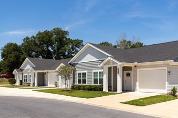 a house with a gray roof and a white garage door